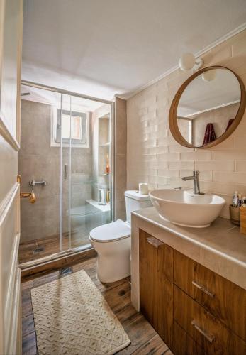 a bathroom with a sink and a toilet and a shower at Nomas SKG Stylish Apartment in Thessaloniki
