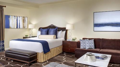 a hotel room with a bed and a couch at Green Valley Ranch Resort Spa Casino in Las Vegas