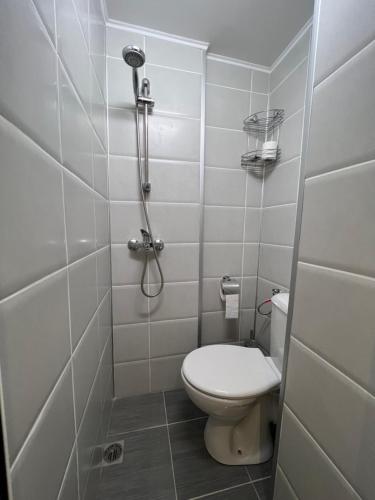 a small bathroom with a toilet and a shower at Studio 5 in Varna City