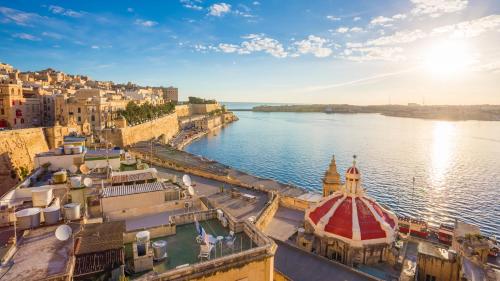 an aerial view of a city next to the water at Blue Waves Apartment with Maltese Balcony in Valletta