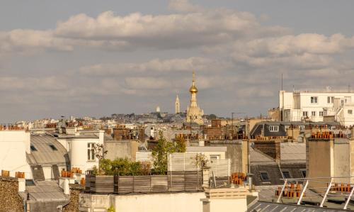 a view of paris from the roofs of buildings at Elysées Ceramic in Paris