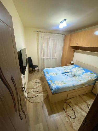 ein kleines Schlafzimmer mit einem Bett und einem TV in der Unterkunft Apartament regim hotelier Deva in Deva