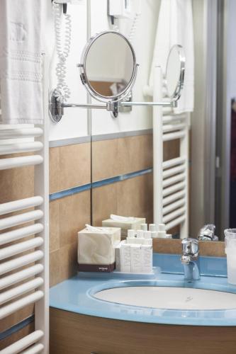a bathroom with a sink and a mirror at Hotel Domus in Marina di Massa
