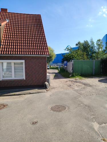 a red brick house with a red roof at Hotel Pension Kirschstein in Wolgast