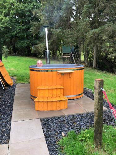 a baby in a hot tub in a park at Shepherds Hut at The Retreat in Oswestry