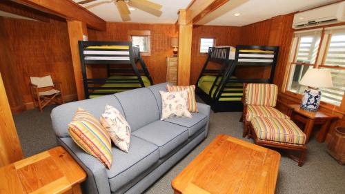 a living room with a couch and two bunk beds at OCEANFRONT, Amazing Ocean and Sound Views, Scrnd Porch, PM1, Ariel in Sanderling