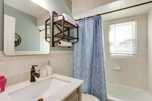 a bathroom with a white sink and a blue shower curtain at Edison Vacation Home 1 Mi to Train Station to NYC in Edison