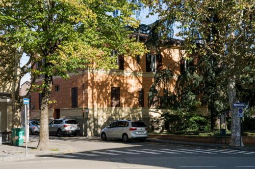 a car parked in front of a building at LaMì Room & Apartment in Castel San Pietro Terme
