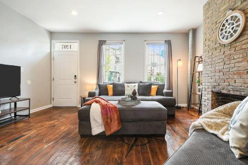 a living room with a couch and a fireplace at HostWise Stays - The "Row" House - Beautiful Space, Two King Beds in Pittsburgh
