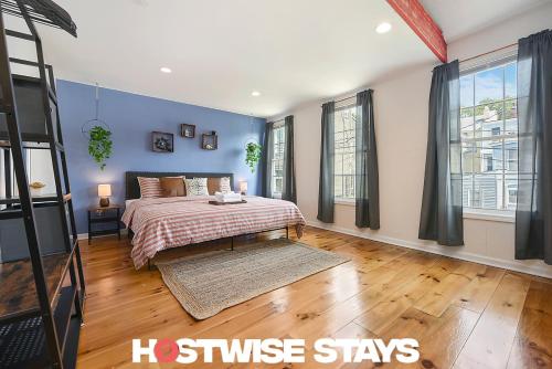 a bedroom with a king sized bed with blue walls at HostWise Stays - The "Row" House - Beautiful Space, Two King Beds in Pittsburgh