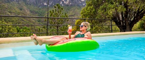 a woman is sitting on an inflatable at Glamping San Isidro in Laguna de Sánchez