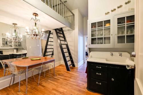 a kitchen with a table and a sink and a staircase at Hidden Gem in Decatur - Historic Main St Location in Decatur