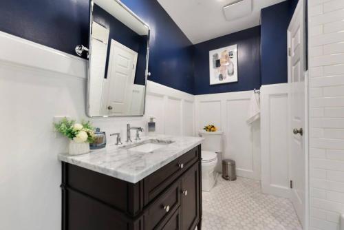 a bathroom with blue walls and a sink and a toilet at Great Balcony Views, Patio, Minutes to Stadiums in Pittsburgh