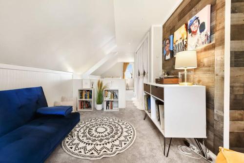 a living room with a blue couch and a white cabinet at HostWise Stays - The Geneva - Easy Walk to Childrens in Pittsburgh