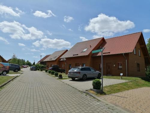 a row of houses with cars parked in a driveway at Ferienhaus Ostara in Hasselfelde