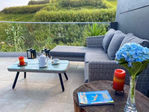 a patio with a couch and a table with a vase at Terra Vivaz - Porto Bay Villa in Porto Formoso