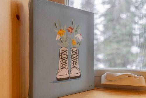 a picture of two boots with flowers in them at The Alaskan Dream Lodge in Fairbanks
