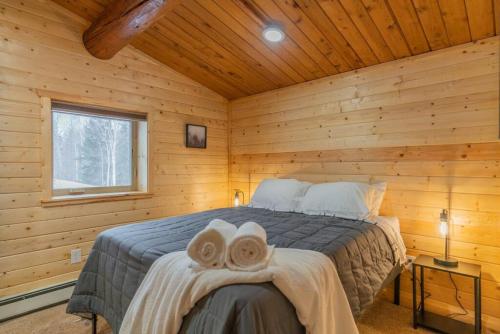 a bedroom with a bed in a wooden cabin at The Alaskan Dream Lodge in Fairbanks