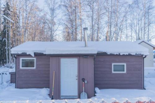 a small shed with snow on top of it at The Little Airport Getaway in Fairbanks