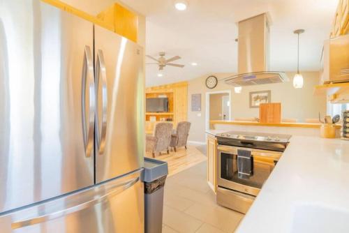 a large kitchen with a stainless steel refrigerator at The Chena River House South Suite in Fairbanks
