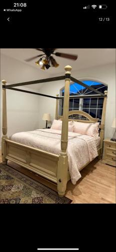 a bedroom with a bed with a ceiling fan at Cozy greenery view among comfort in Haledon