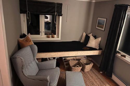 a living room with a couch and a window at Serviced Farmhouse - Kvaløyvågen Gård in Kvaløya