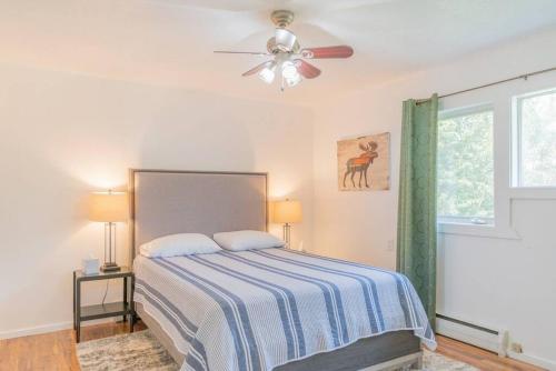 a bedroom with a bed and a ceiling fan at Life is Better on the River in Fairbanks