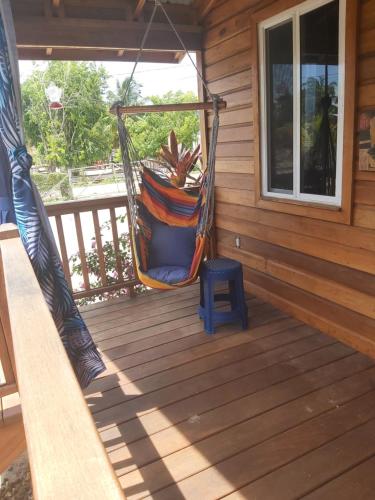 a hammock on the porch of a cabin at Bella Vita Casitas in Placencia Village
