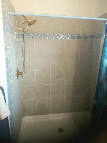 a bathroom with a shower with a shower curtain at Bella Vita Casitas in Placencia Village