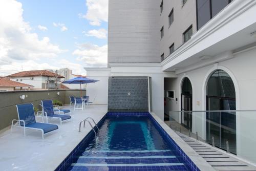 a swimming pool on the balcony of a house at Faro Hotel Taubaté in Taubaté