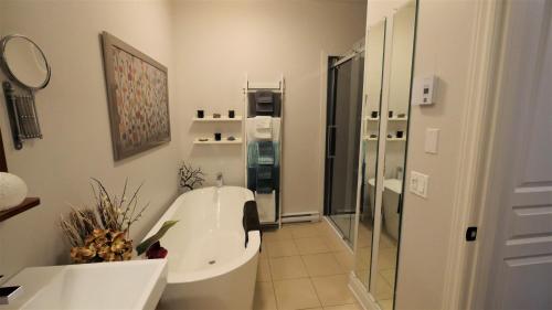 a bathroom with a toilet and a sink and a shower at Le 204 Champlain Bromont in Bromont