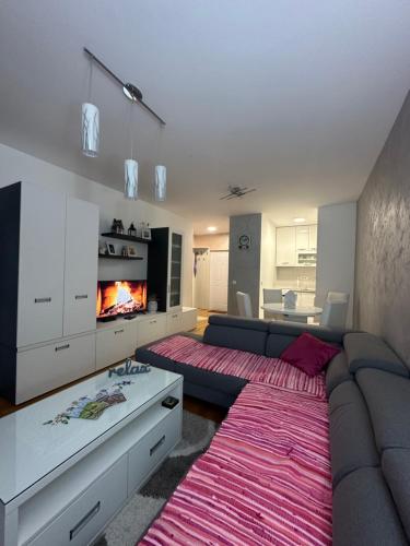 a living room with a couch and a fireplace at Apartman Terzić in Palisad