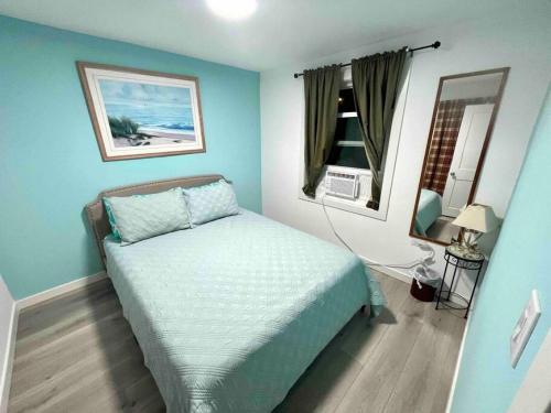 a bedroom with a bed in a blue room at Beachy Paradise in Clearwater Beach