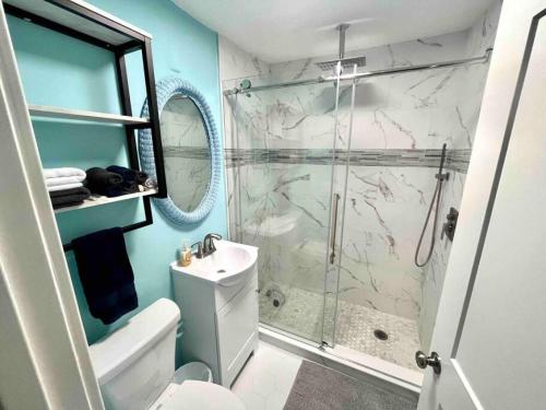 a bathroom with a shower and a toilet and a sink at Beachy Paradise in Clearwater Beach