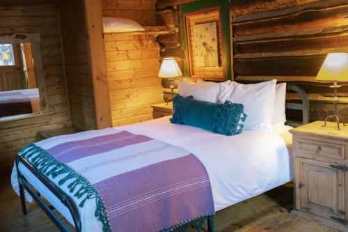 a bedroom with a bed in a log cabin at Beyul Retreat in Meredith