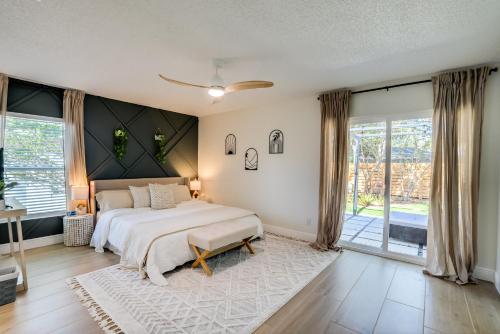 a bedroom with a bed and a large window at Cozy Clearwater Getaway Beach, Spa, and Luxury in Clearwater