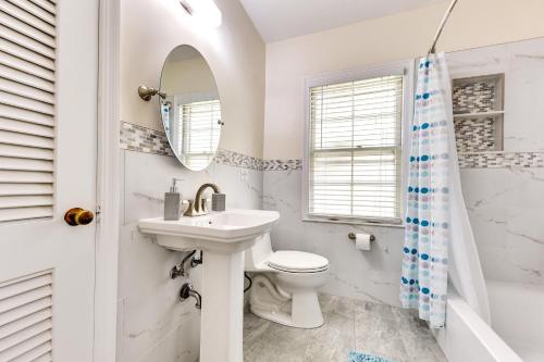 a white bathroom with a sink and a toilet at Jacksonville Vacation Home with Trout River Access in Jacksonville