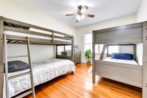 a bedroom with two bunk beds and a ceiling fan at Jacksonville Vacation Home with Trout River Access in Jacksonville