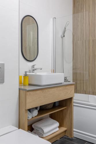a bathroom with a sink and a bath tub at Sea On Mamaia in Mamaia
