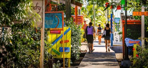 a group of people walking down a sidewalk at Bella Vita Casitas in Placencia Village
