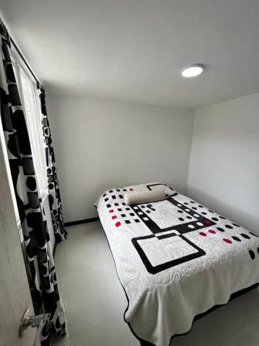 sypialnia z łóżkiem z czarno-białą kołdrą w obiekcie Centro Bogotá campanario w mieście Bogota