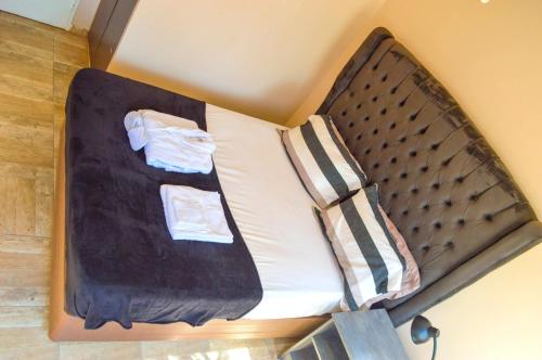 a small bed in the corner of a room at Fantastic location 1-Bed Apartment in Harare in Harare