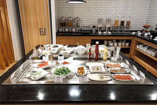 a buffet line with many different types of food at Holiday Inn Express - Astana - Turan by IHG in Astana