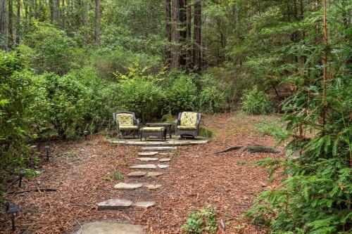 two chairs and a table in the middle of a forest at Fern Woods - Hot Tub Redwoods Dog Friendly in Guerneville