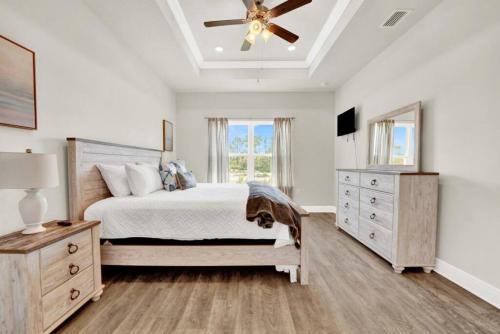 a bedroom with a bed and a ceiling fan at Joe's Beach House in Highland View