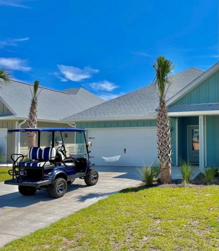a golf cart parked in front of a house at Joe's Beach House in Highland View