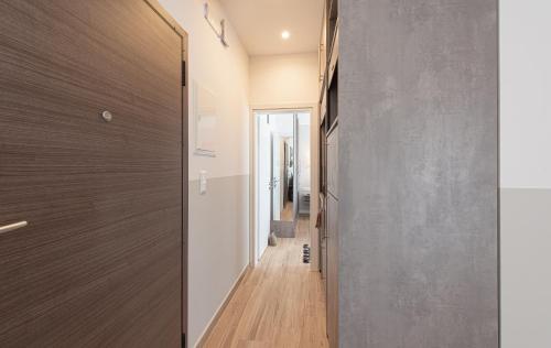 a hallway of a house with a wooden door at Iviskos Apartment - Hellenic Apartments Avlona in Oinófita