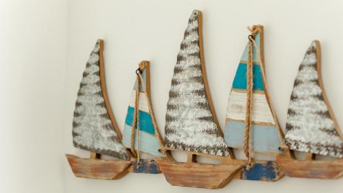 four miniature christmas trees hanging on a wall at Wee Jules By The Sea in Anstruther
