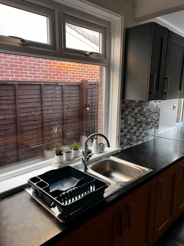 a kitchen counter with a sink and a sink at Barton BnB 