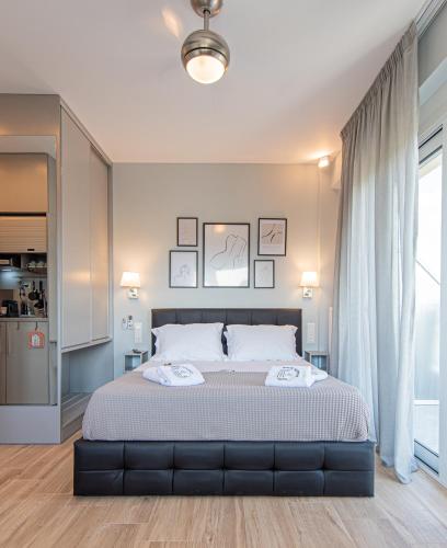 a bedroom with a large bed with white sheets at Masticha Apartment - Hellenic Apartments Avlona in Oinófita